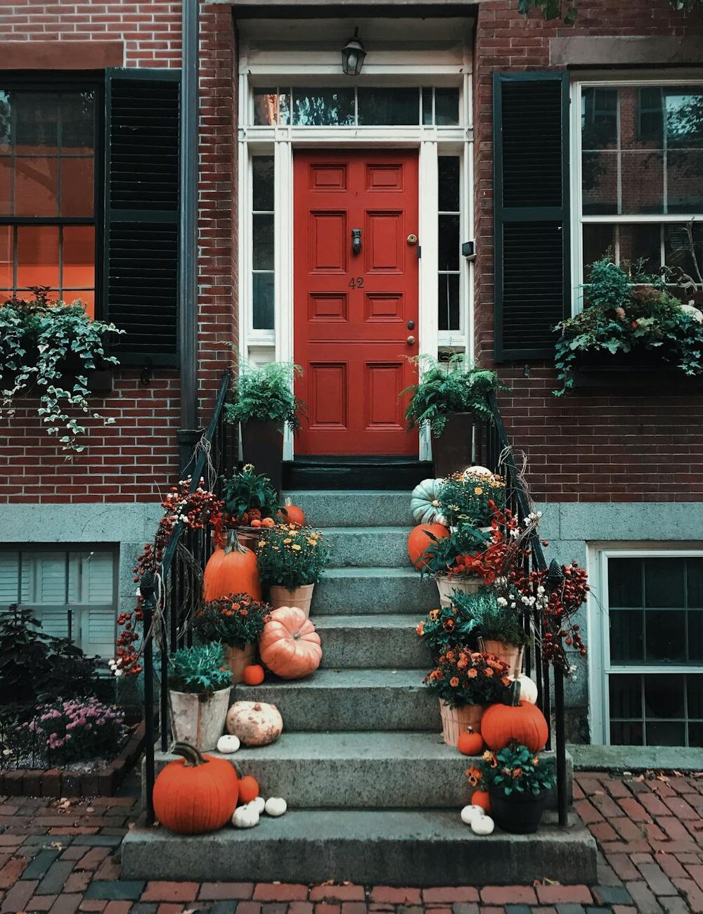 pumpkins on stairs in front of a door