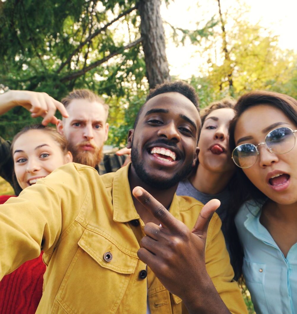 happy friends taking a fun selfie outdoors