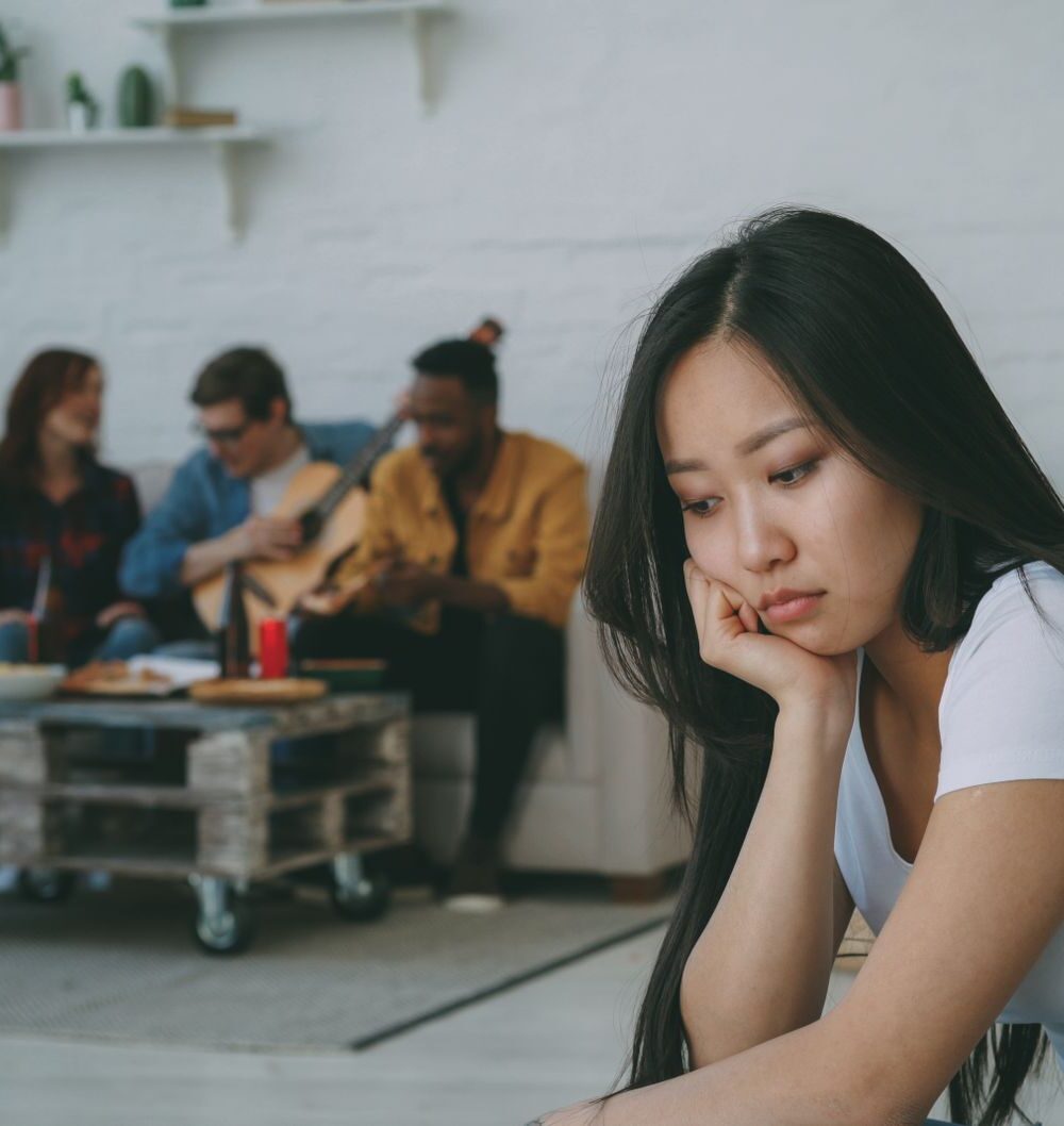 young woman feeling left out at a social gathering