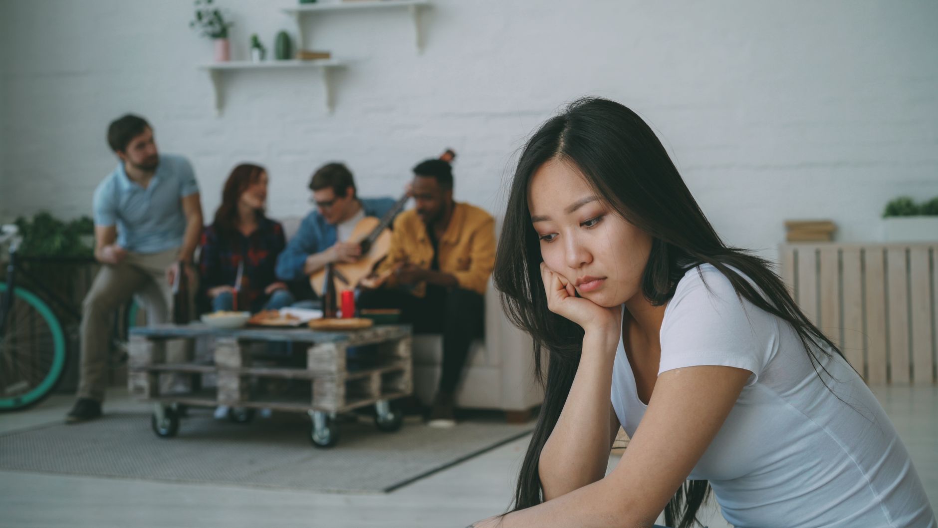 young woman feeling left out at a social gathering
