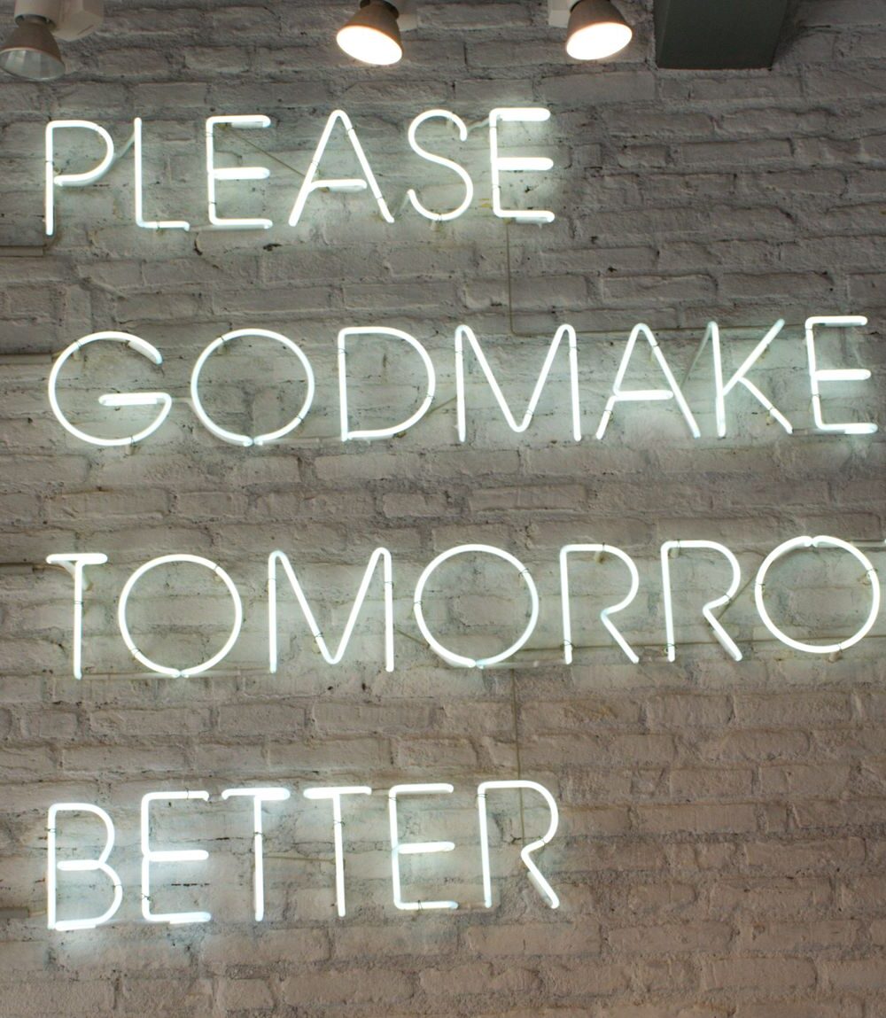 illuminated signage on brick wall