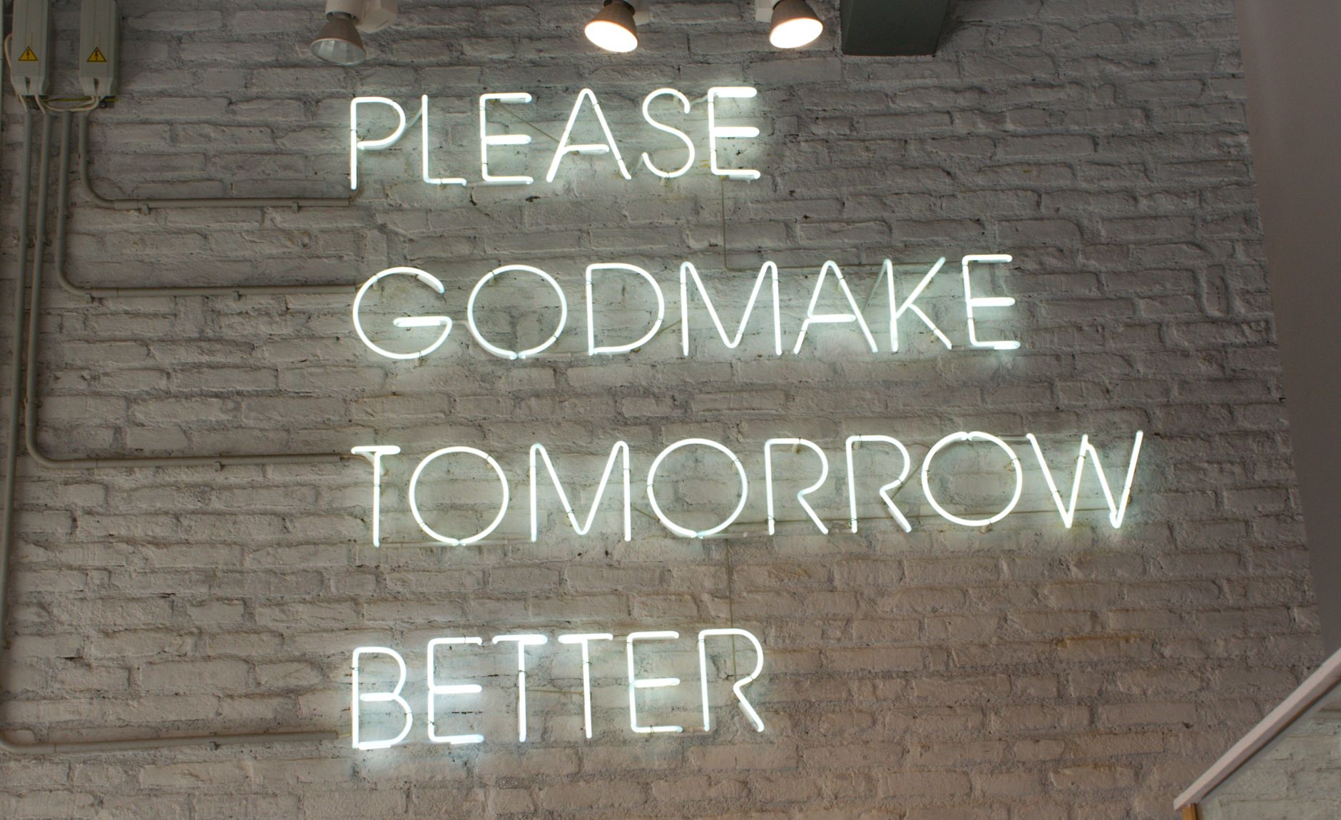 illuminated signage on brick wall
