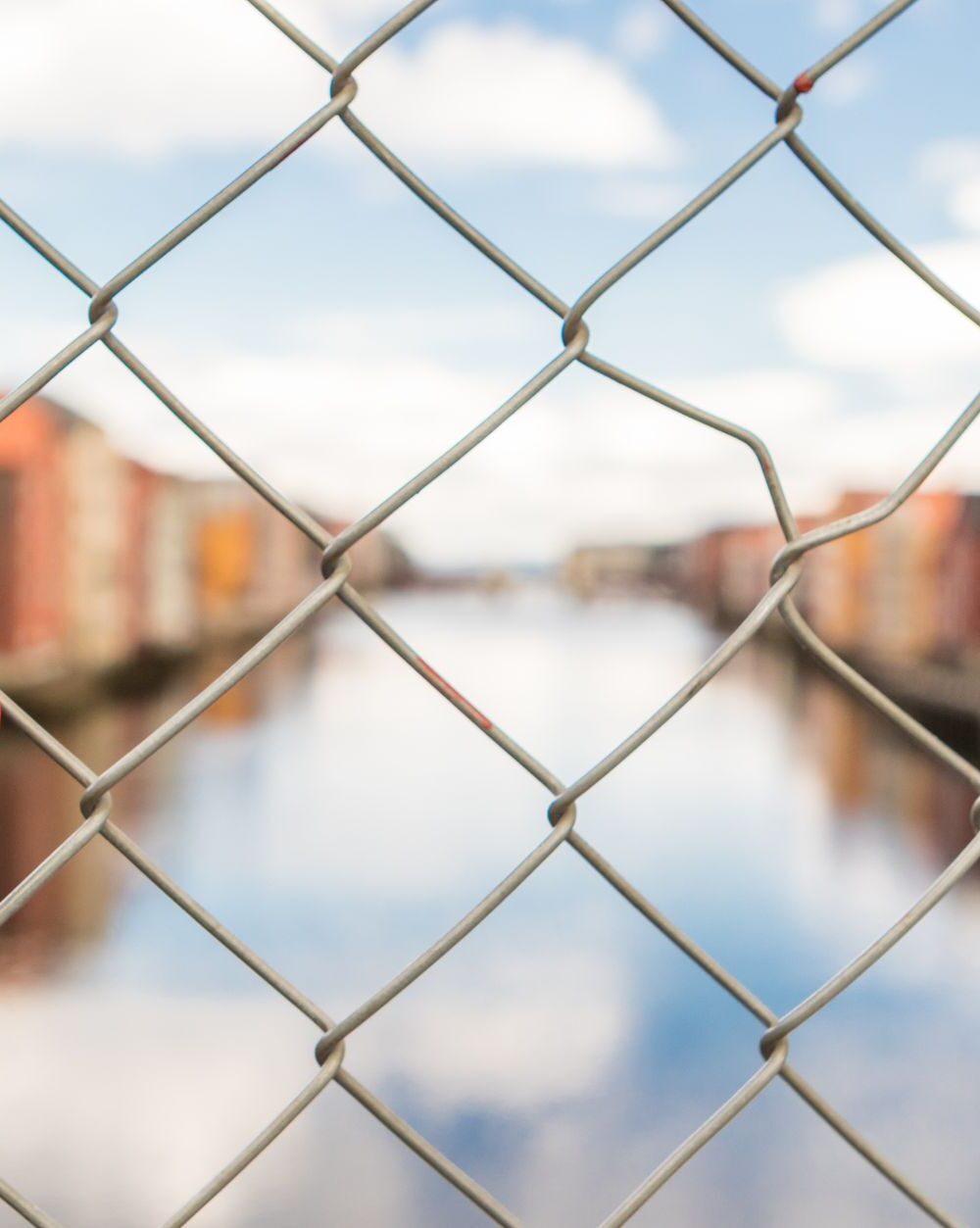 red lock in gray link fence